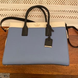 Blue Kate spade bag with striped fabric lining.